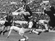Inter Milan centre-forward Pino Boninsegna leaps high over Lazio's Giorgio Papadopulo during their match at the Olympic Stadium in Rome. On the left is Inter Milan's Giacinto Facchetti.